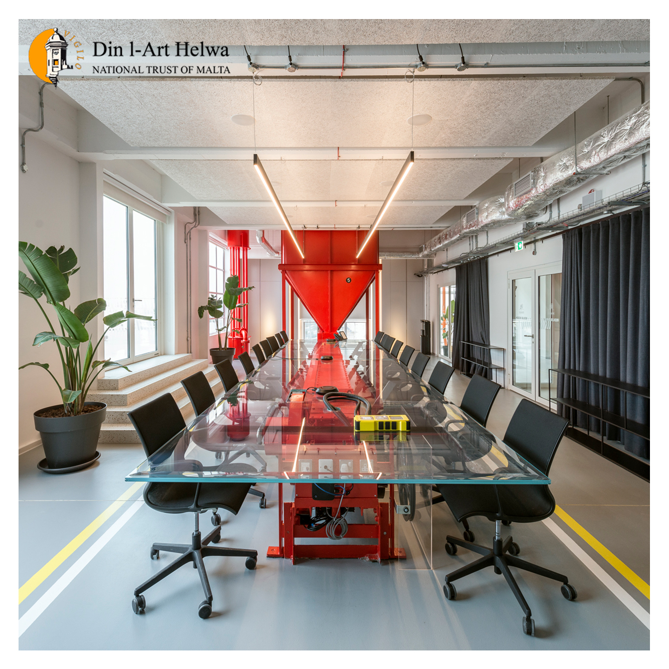 Interior of 'The Redler' meeting room at The Brewhouse, featuring a restored red industrial conveyor centerpiece, repurposed as a table, showcasing innovative design and functionality by Ritchie Studio