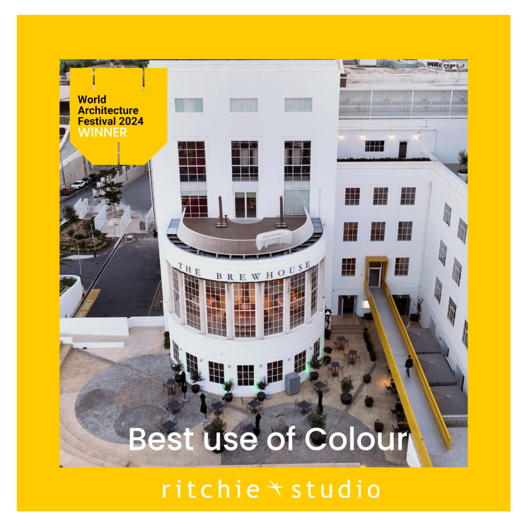 Aerial view of The Brewhouse building featuring bold yellow accents and elegant white façades, winner of the World Architecture Festival 2024 Best Use of Colour award, designed by Ritchie Studio.